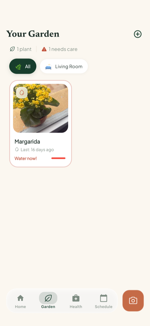 Bloom's garden view showing a saved plant with a watering alert and a camera button